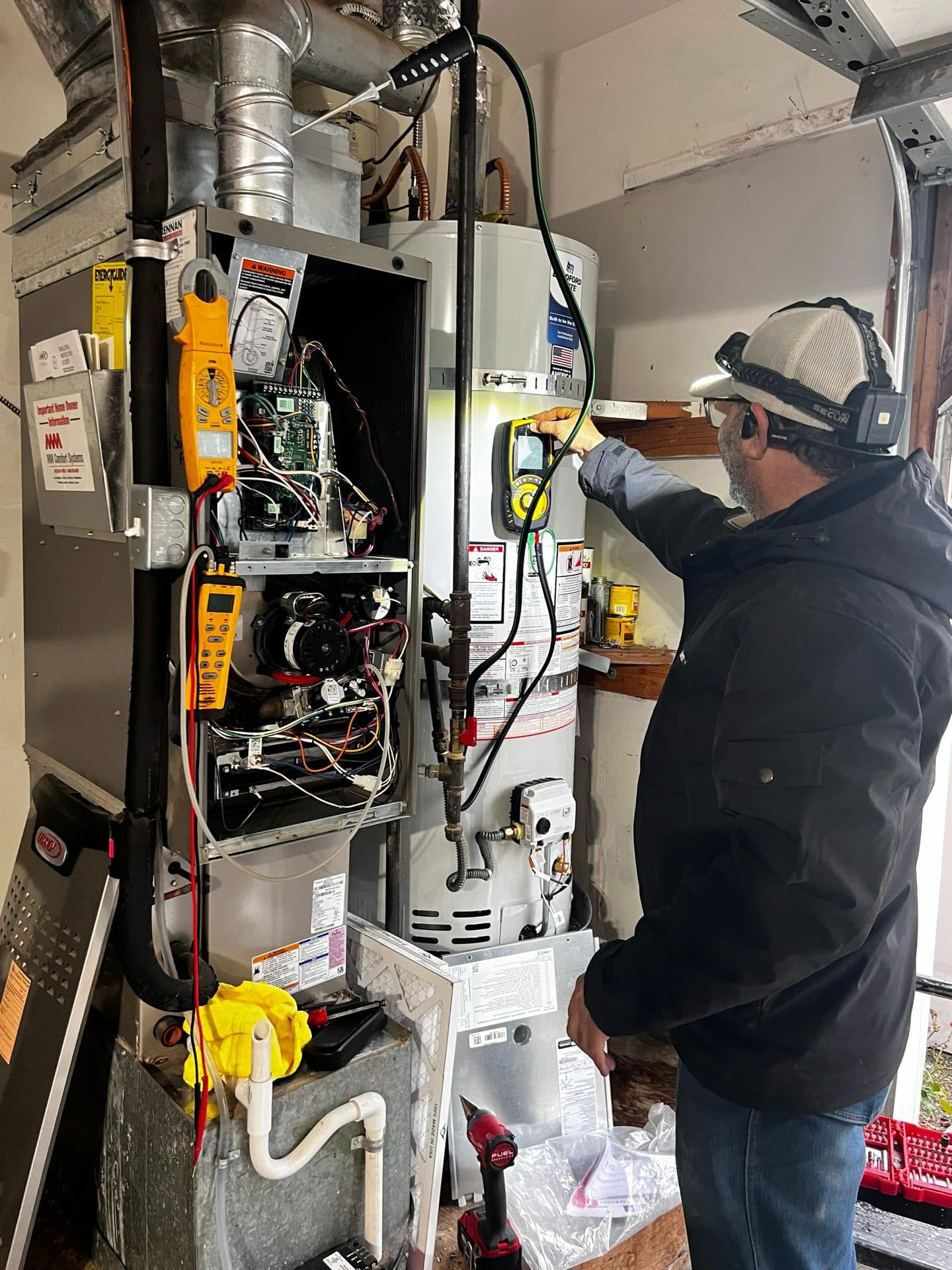 Aakool technician repairing a furnace in a Seattle home
